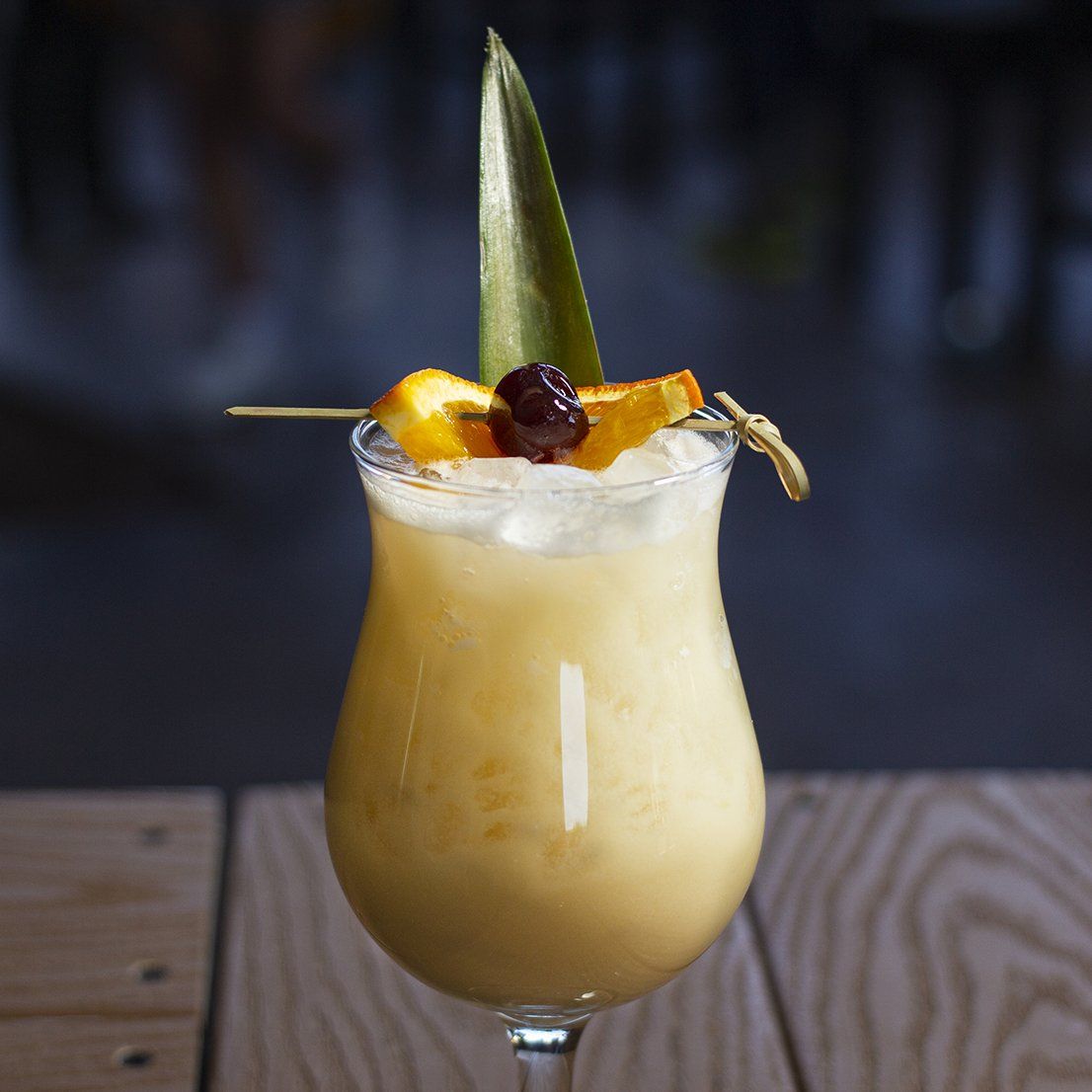 Piña colada garnished with pineapple and cherries